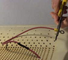 Attaching a ring connector to the high voltage wire.