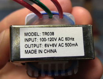 Photo of a transformer label for determining using labelled input/output voltages.