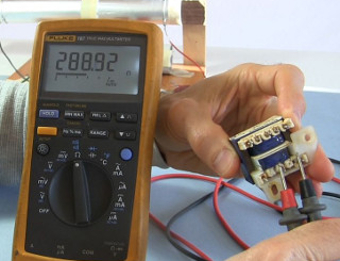 Photo showing measuring the resistance of a transformer coil.