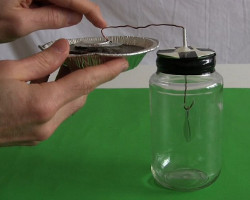 Inductively charging an electroscope using top of the electret.