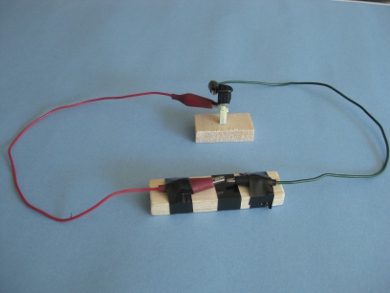 The test setup with wires connected to the piezoelectric igniter and leading to a spark gap as they would in a spud gun.