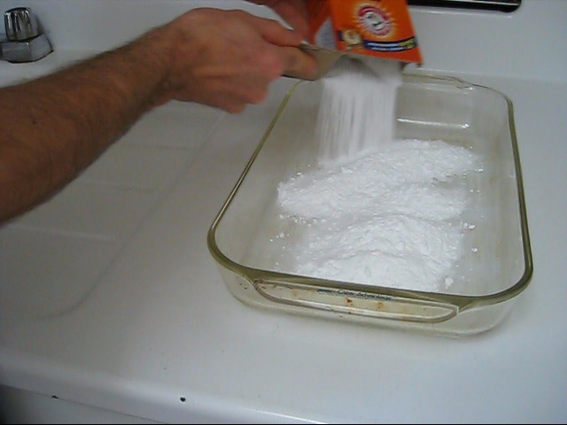 Step 1 in making rochelle salt piezoelectric crystal, put the baking soda in a Pyrex container.
