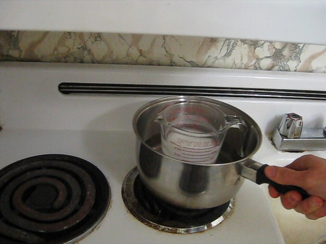 Step 3. Put the container in the saucepan on the stove.