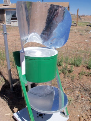 Art's hybrid solar oven showing the parabolic reflector on the
      bottom for reflecting light onto the bottom of the coffee brewing
      cooking pot and the funnel reflector on top.