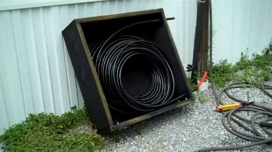 Everything painted black in the solar hot water collector and the PEX tubing in place.