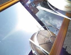 Sunlight reflected from the mirror covering the bottom of the pan in the fresnel lens and mirror solar cooker.