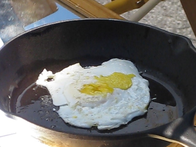 Eggs fried using a fresnel lens solar cooker.