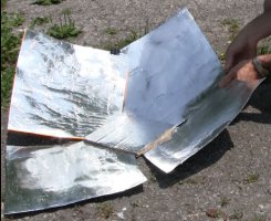 Clipping the reflectors of the Copenhagen solar cooker together.