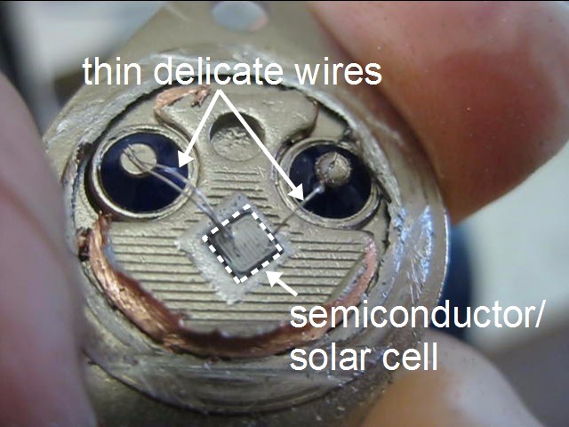 The semiconductor material (solar cell) and delicate thin wires for the base and emitter inside the 2N3055 power transistor.