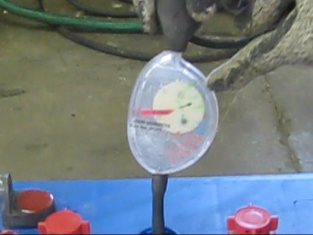 Close up showing the numbers on the dial for a dial type hydrometer for measuring specific gravity in batteries.