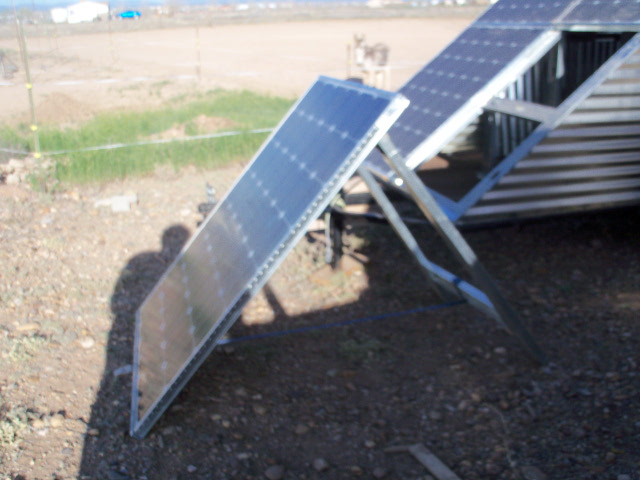 Lower solar panel removed from mobile trailer and mounted on independent A-frame for camping or charging truck battery.