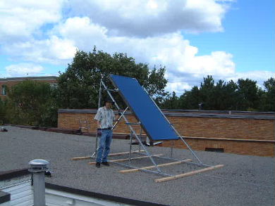 The author beside a single Enerworks flat panel standing on a flat roof.