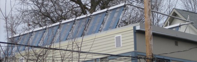 Photo of a 160 tube evacuated tube system installed on a flat roof.