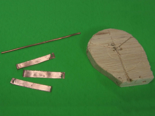 The parts for the curie temperature motor: three copper strips, copper wire and a wooden template..
