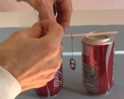 Step 3 for making the Franklin's bell - tape the straw to one can.