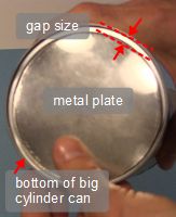 The metal displacer held against the cylinder to show the gap size.