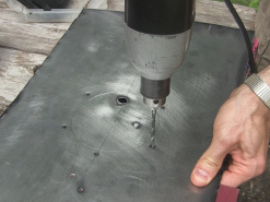 Drilling the holes in the metal plate for the Stirling engine.