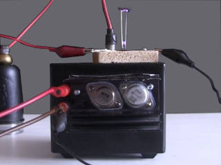 DIY high voltage power supply made from a flyback transformer with built-in diodes powering a jacob's ladder.