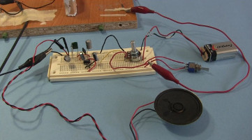 Testing the crystal radio amplifier circuit on a temporary breadboard.