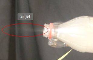 Smoke coming out as a jet from one of the bottles.