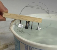 Quickly cooling the nitinol wire in water.