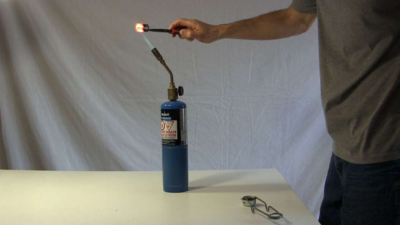 Bluing the razor blade using a propane torch.