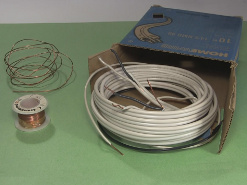 Samples of thick wire showing a roll and household wiring.