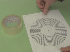 Laying down clear packing tape on the template for the spiral primary coil.