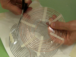 Cutting the spiral coil from the template.