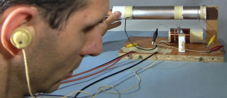 Crystal earpiece in use with a homemade crystal radio shown on this page.