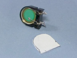 The exposed piezoelectric crystal from the microwave oven's piezo speaker and the homemade plastic cover.