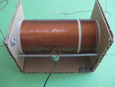 Compact homemade tunable coil for crystal radio made with cardboard form.