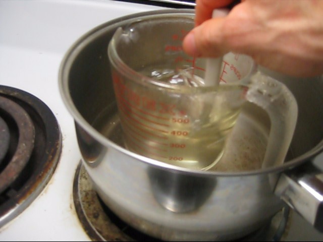 Step 5 in making rochelle salt piezoelectric crystal, the solution is clear and doesn't bubble anymore.