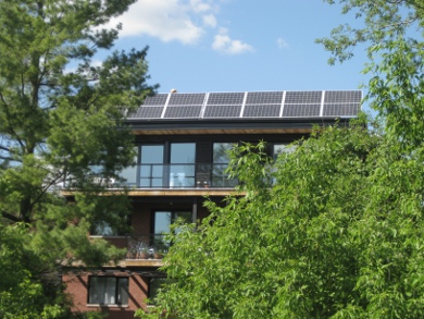 Ottawa passive solar house designed by Chris Straka of VertDesign, including green roof, abundant south facing windows for heating in winter and overhangs to shade them in summer, superb insulation, a geothermal system for heating and cooling, high performance doors and very energy efficient windows.