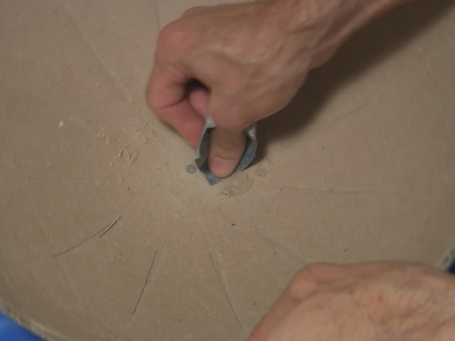 Sanding resin lump from inside the ball at the equator.