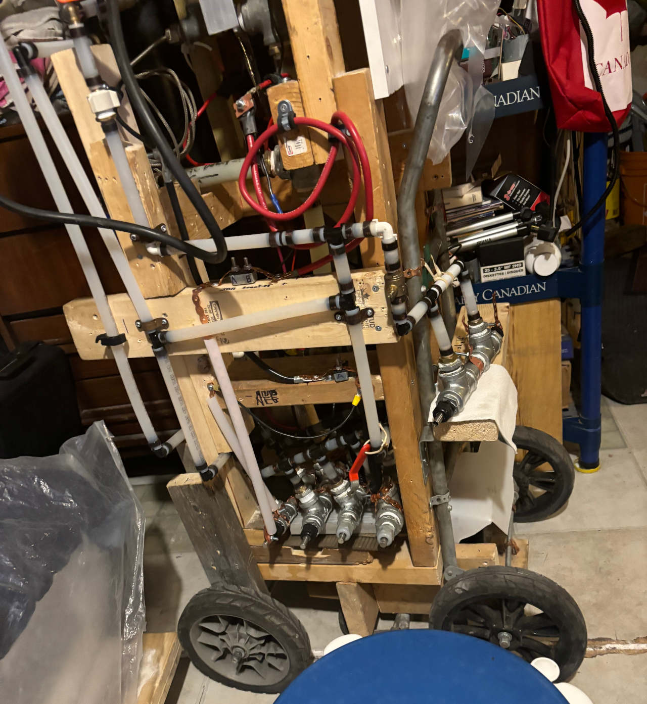 EGEN HHO generator/electrolyzer test stand with 4 EGENs mounted lower inside the stand and one on the outside.