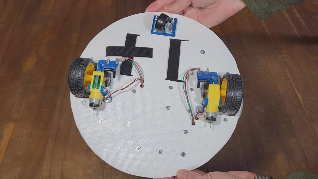 3-wheeled robot bottom view showing the two powered wheels on either side and a caster wheel at the back.