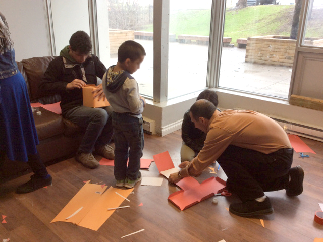 Helping kids make pinhole cameras using poster board.