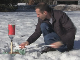 Pumping air into the bottle rocket.