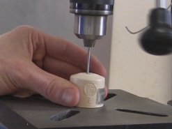 Drilling a hole in the launch pad's PVC cap.