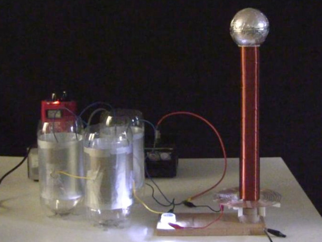 Small spark gap Tesla coil with capacitors made from soda bottles.